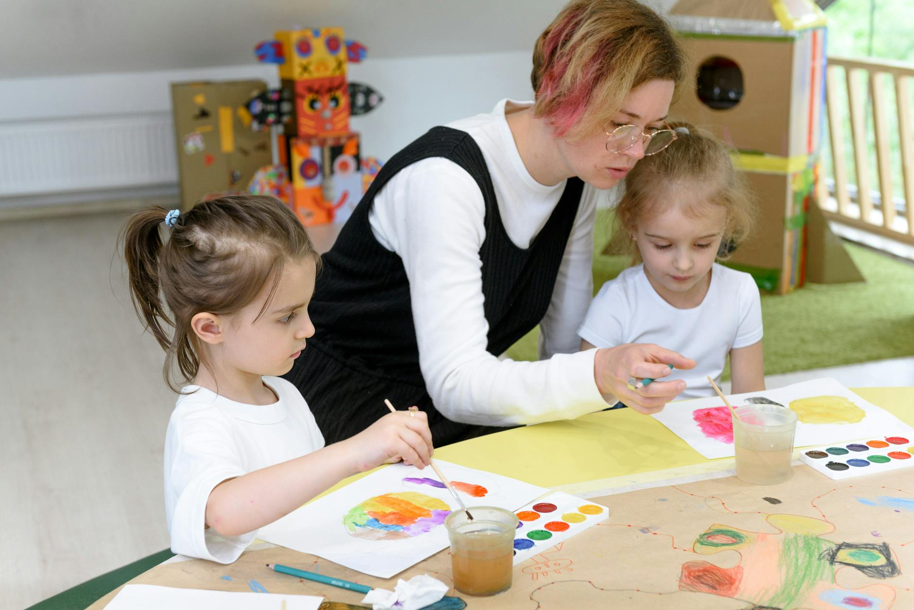 a woman teaching arts to preschoolers
